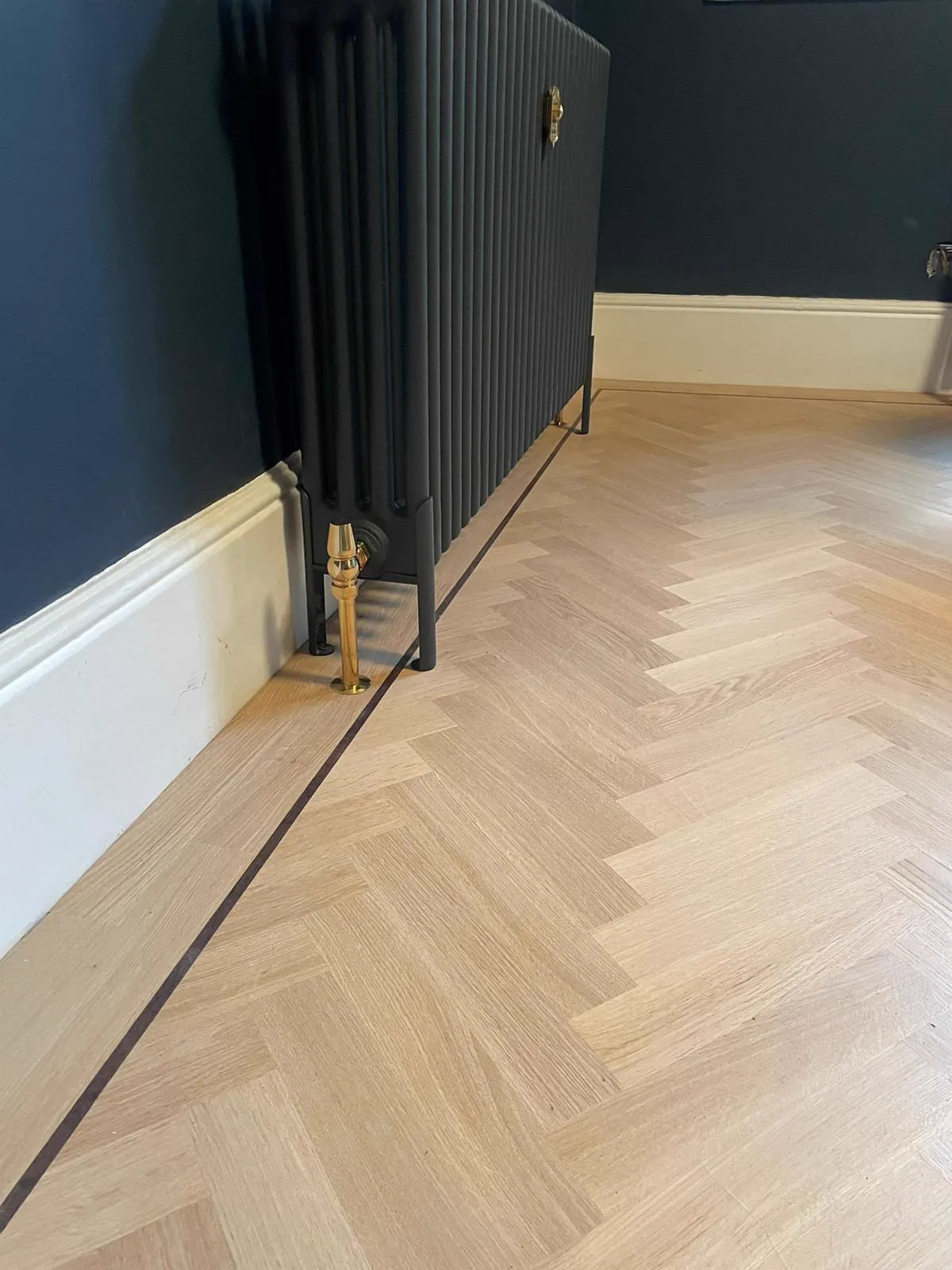 Restored herringbone wood floor in a Balham SW12 reception room