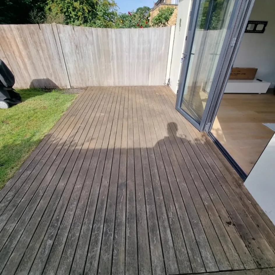 Weathered Battersea SW11 garden decking sanded back to fresh clean timber by Howard Naish on a summer day
