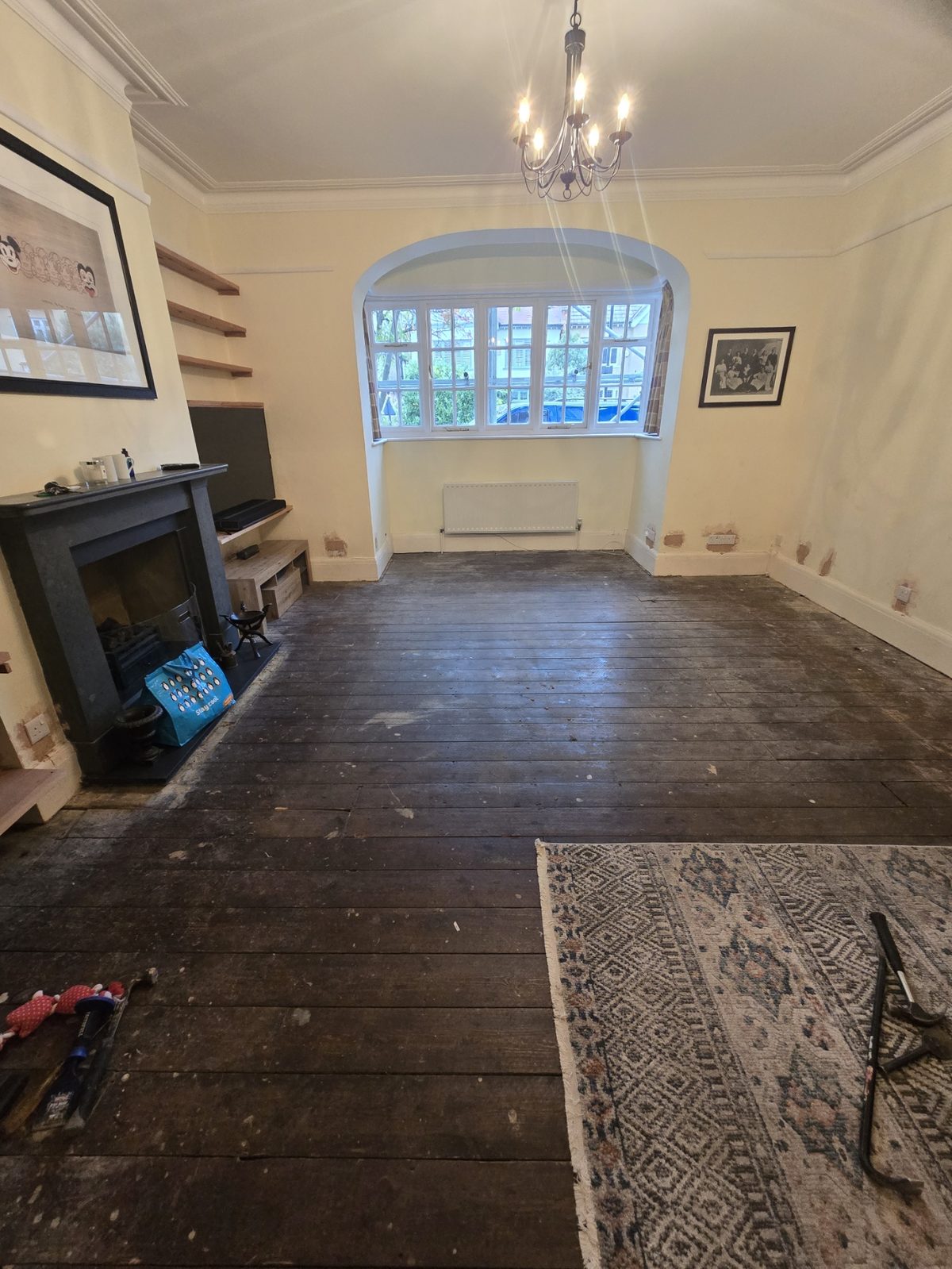 Pine floorboards mid-sand with fresh timber revealed
