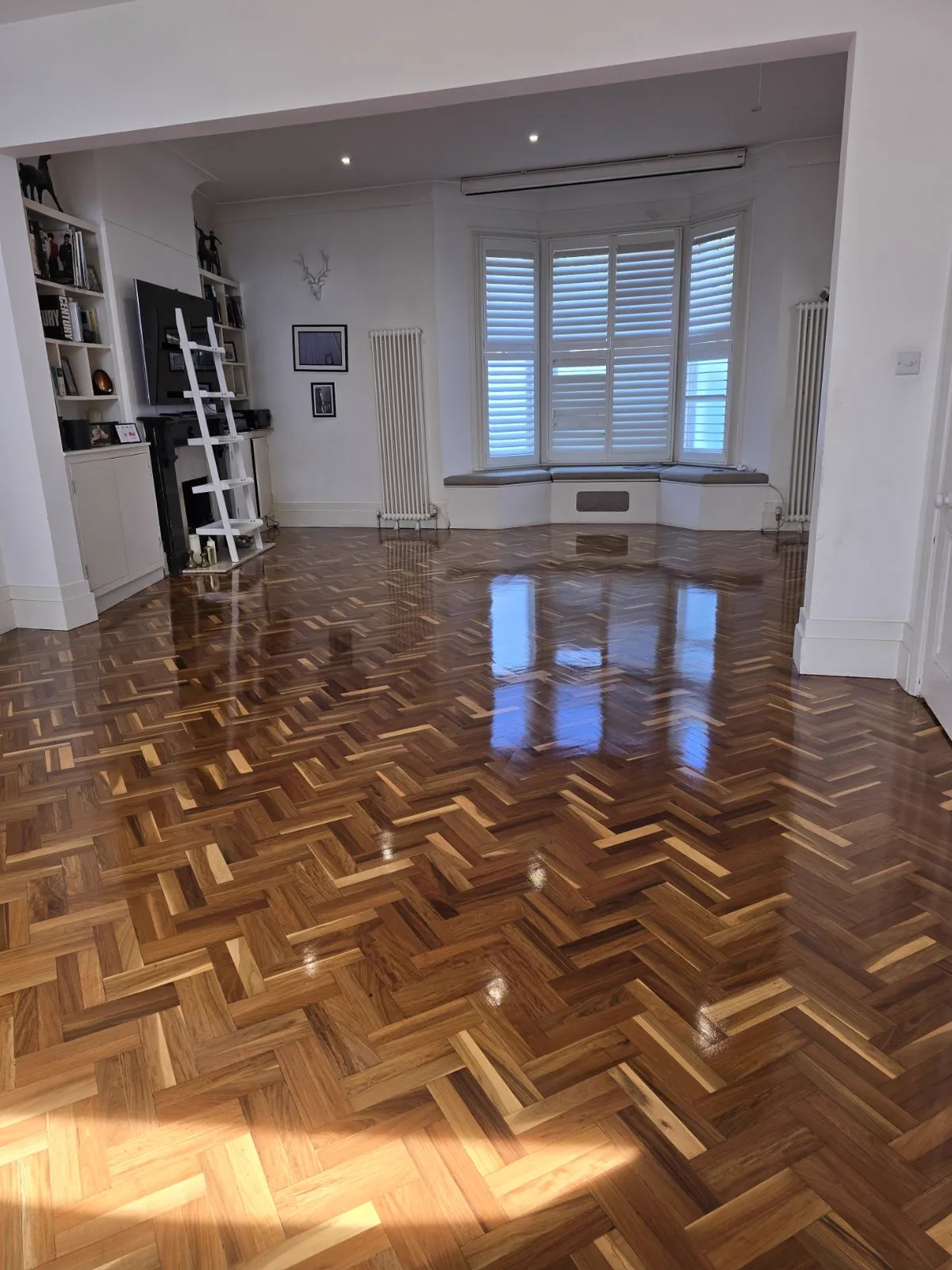Restored herringbone parquet floor with high-gloss finish in a Clapham SW4 home