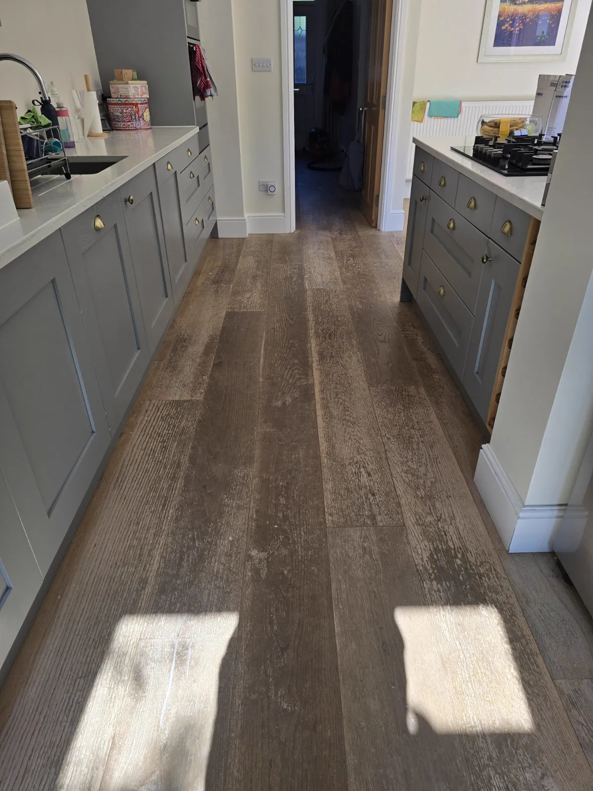 Worn oak plank floor in a Clapham SW4 kitchen before sanding