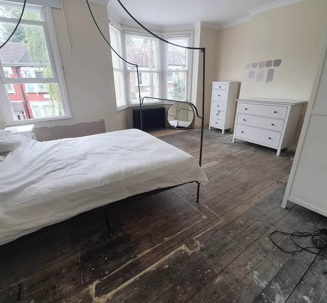Grey worn original pine floorboards in the same Crystal Palace bedroom before sanding