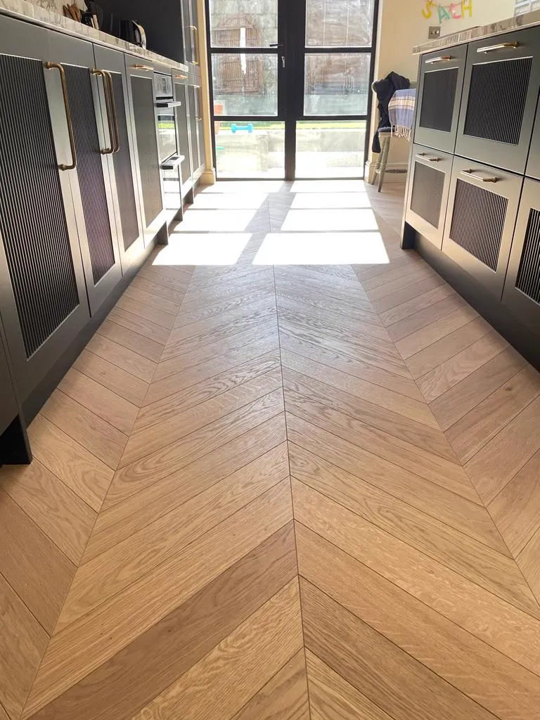 Warm-toned chevron wood floor in a Dulwich kitchen