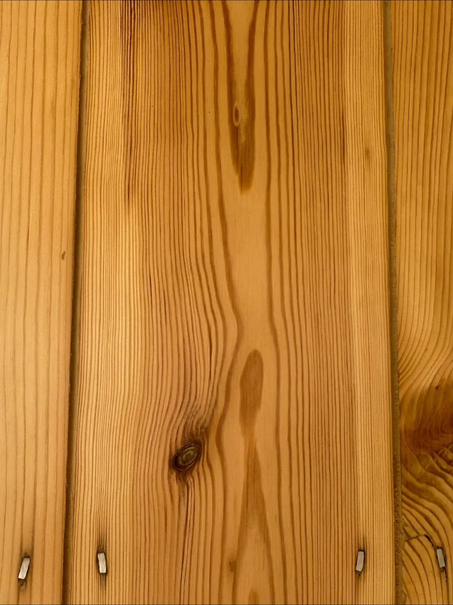 Medium oak toned flexible filler between warm-toned original pine floorboards