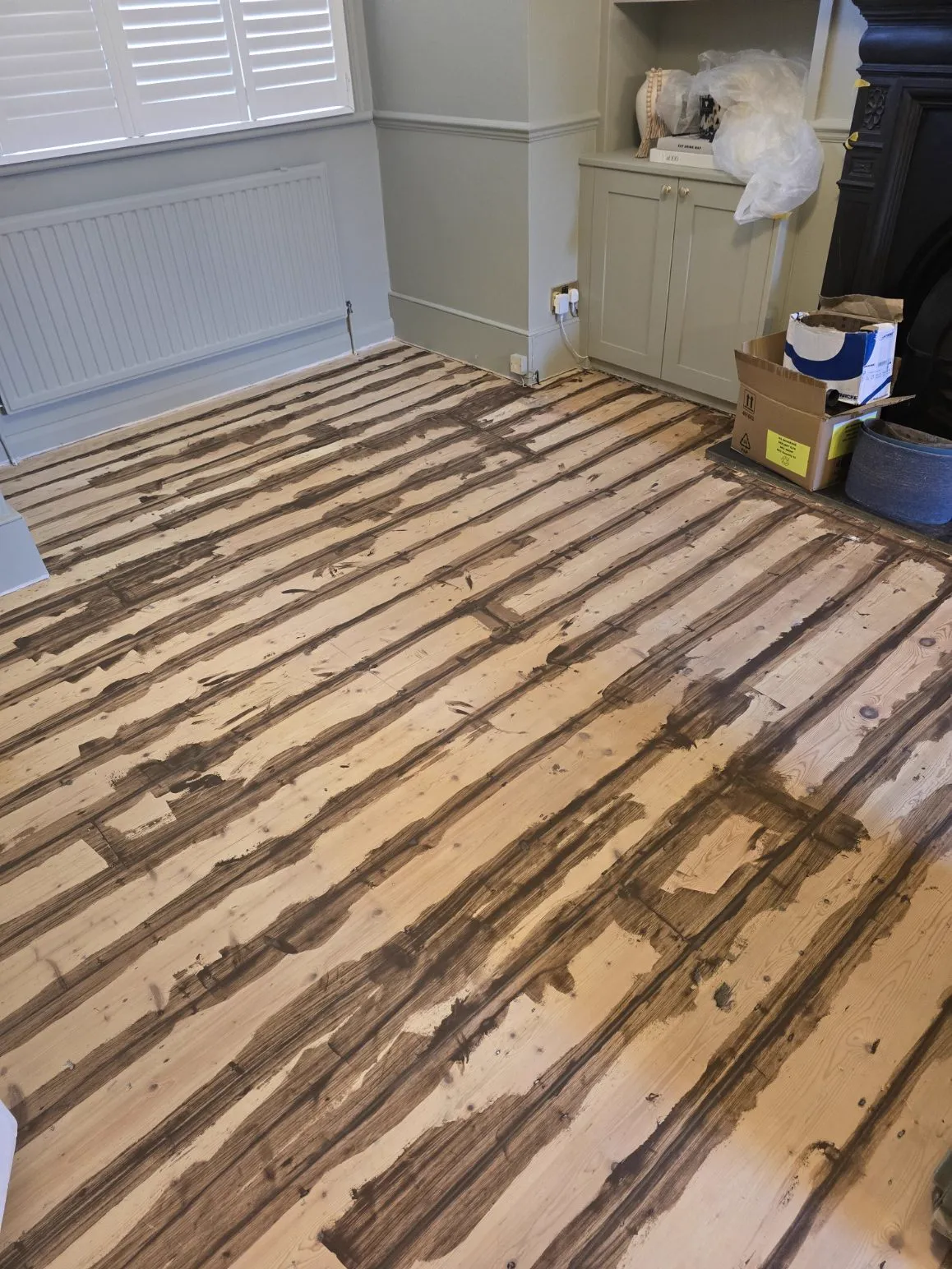 Pine floorboards with flexible filler freshly applied along every gap