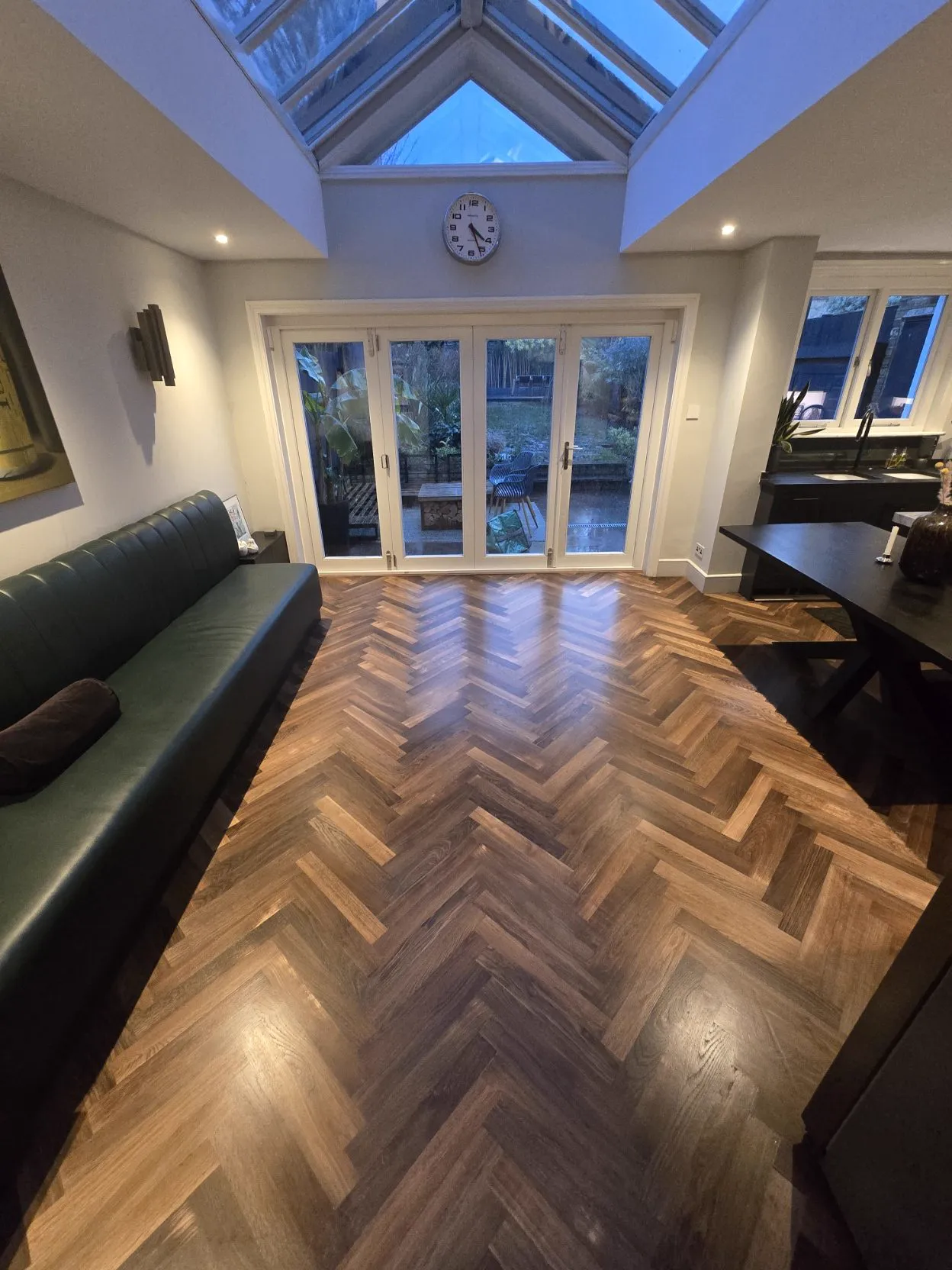 Warm oiled herringbone floor in a family living room in evening light