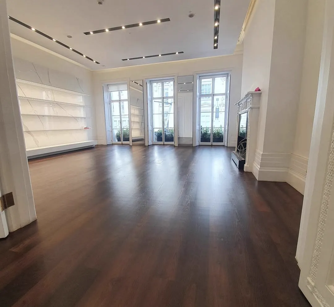 Dark oak plank floor in a Mayfair jewellery showroom, sanded and finished by Howard Naish