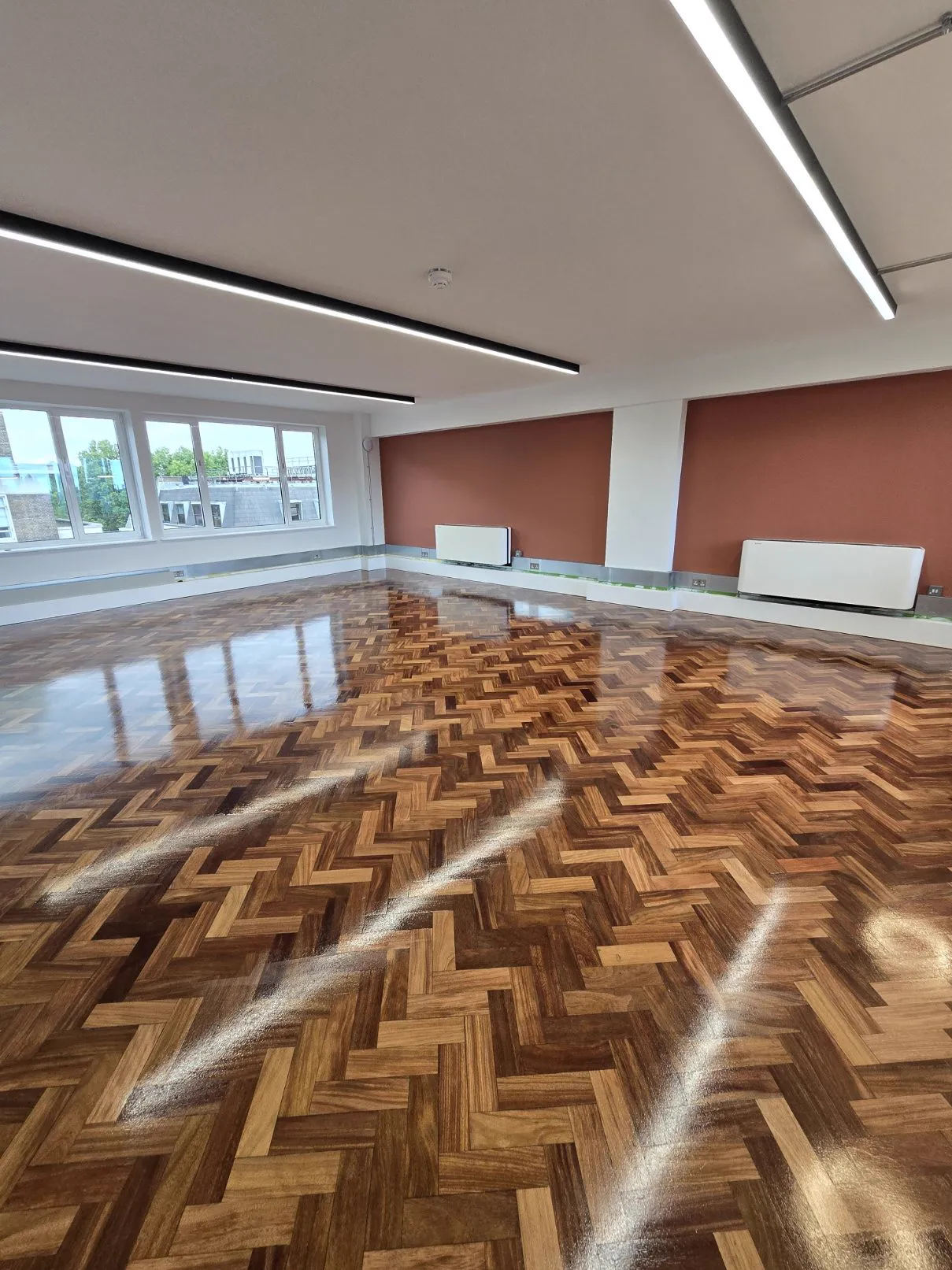 Richly figured hardwood herringbone parquet sanded and refinished by Howard Naish in a Kensington W8 office