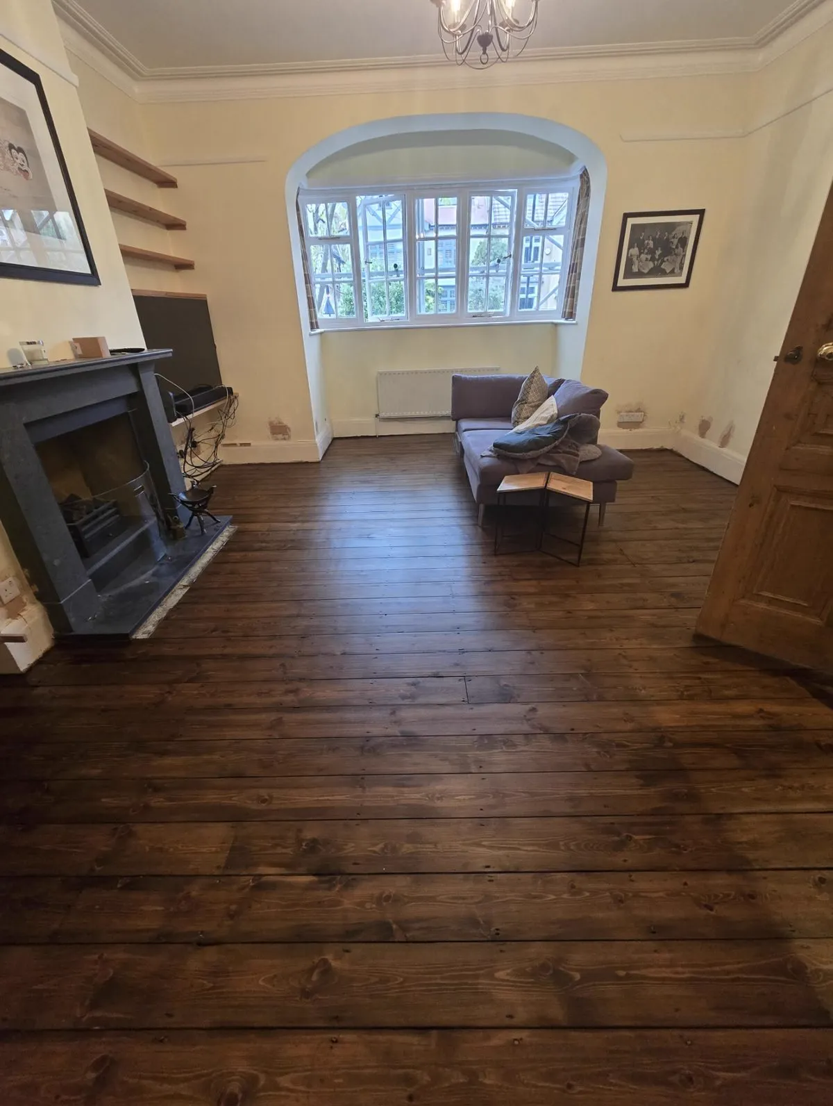 Original pine floorboards restored and finished by Howard Naish, warm grain showing across the whole room