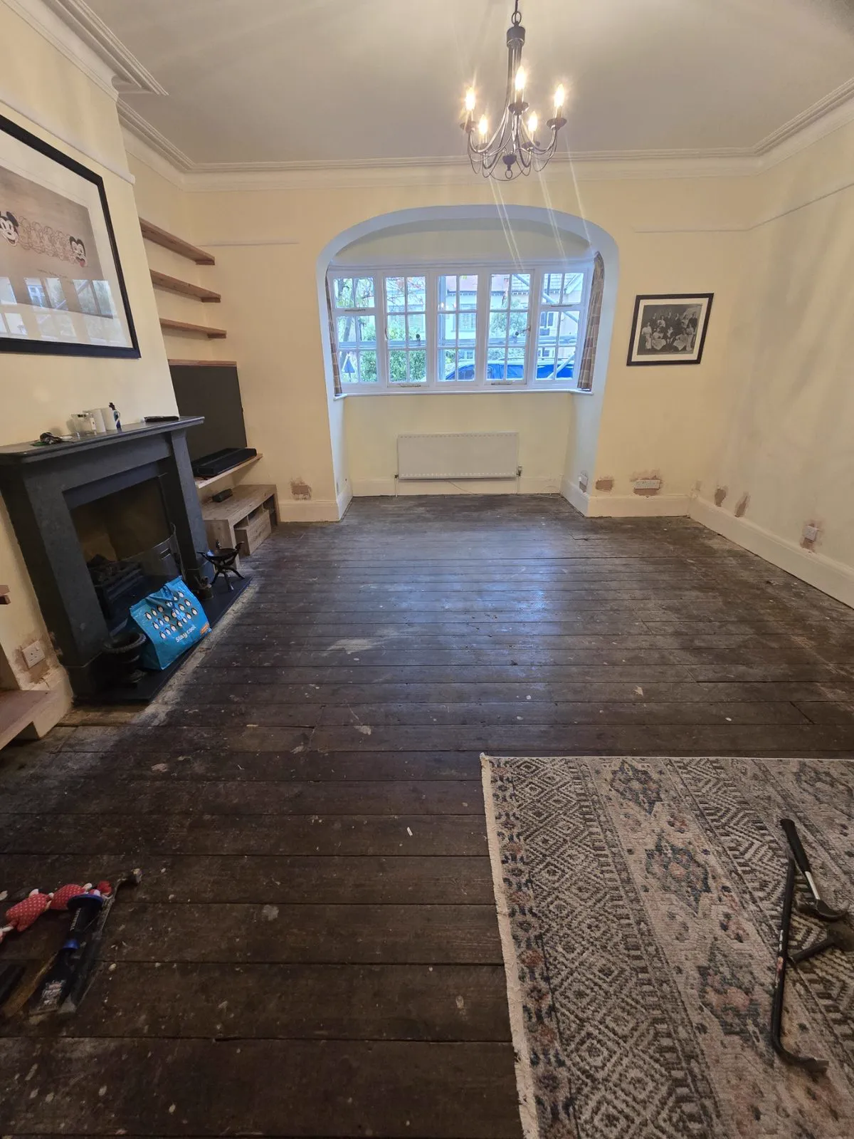 Original pine floorboards freshly uncovered, worn and darkened before sanding