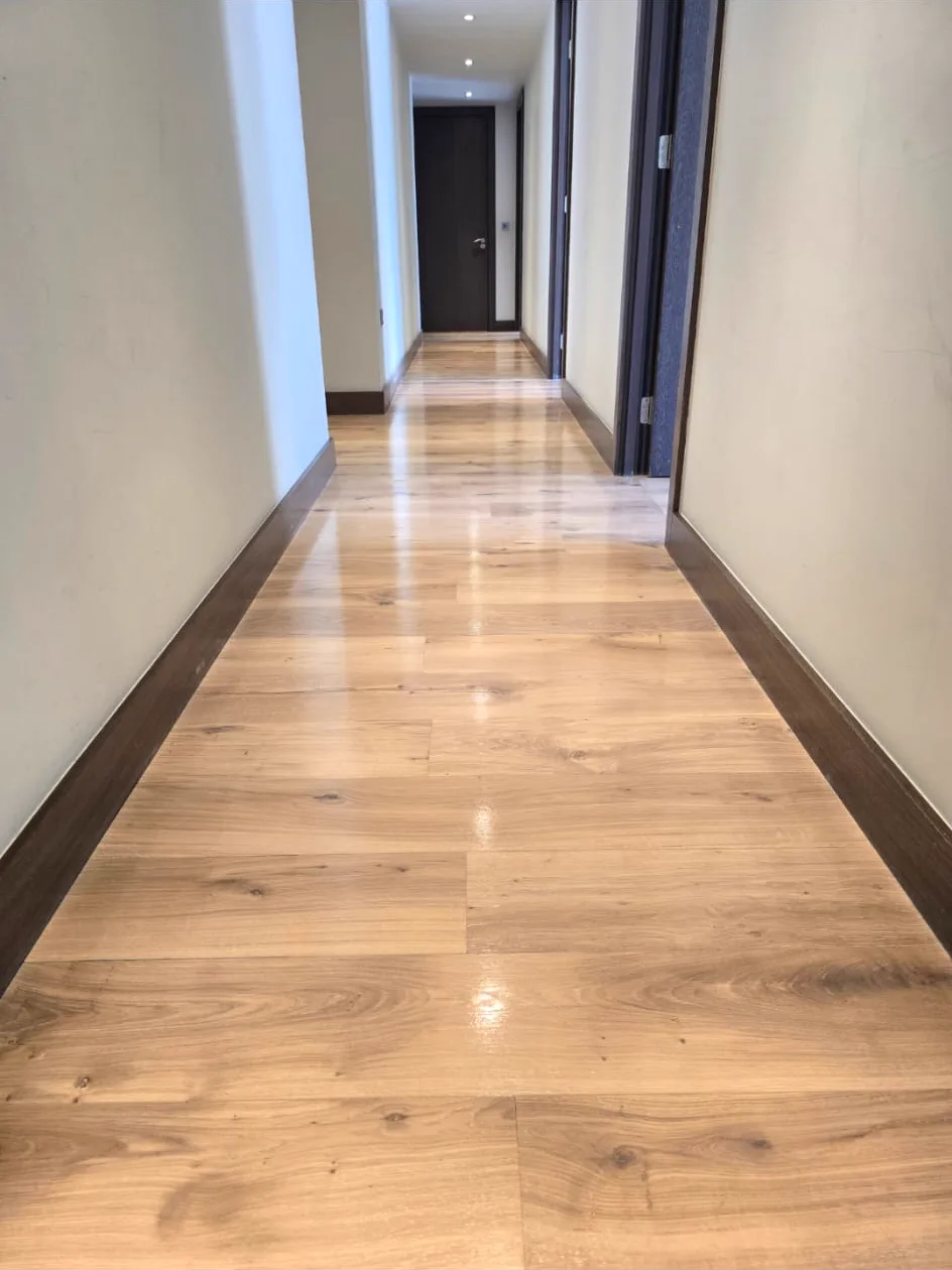 Refinished light oak hallway floor flowing through a riverside Putney SW15 apartment, sanded by Howard Naish