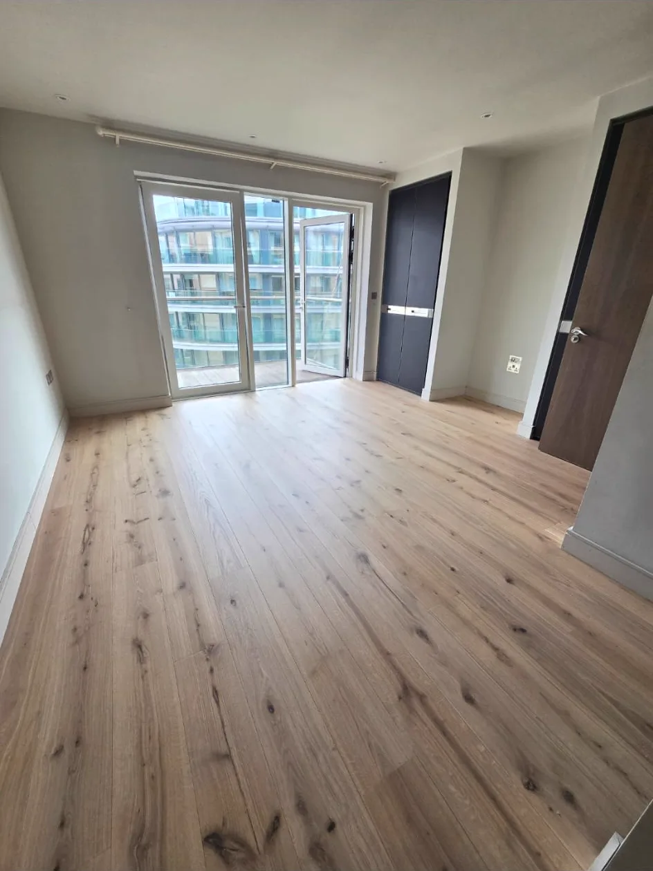 Brand-new engineered oak floor fitted in a Putney SW15 apartment bedroom by Howard Naish