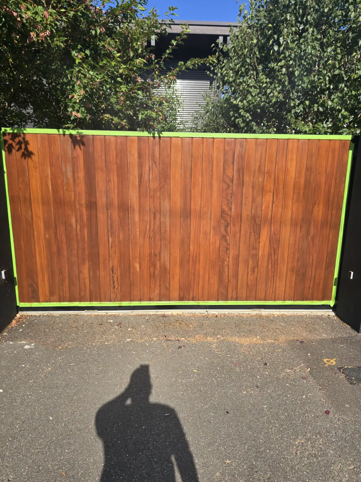 Richmond front door taped up and freshly oiled, rich colour returning to the hardwood slats