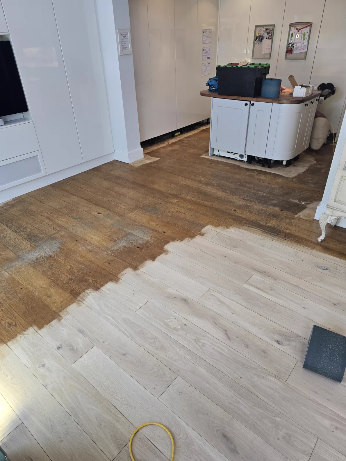 Half-sanded oak floor in Southfields SW18, old orange finish on one side and clean bare oak on the other