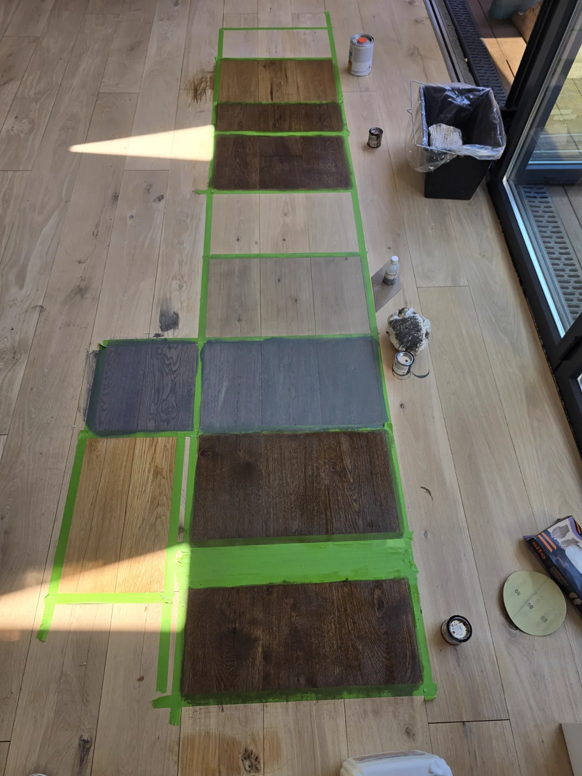 Free stain patch test on sanded oak boards in Southfields SW18, LOBA colours tried side by side on the client's own floor