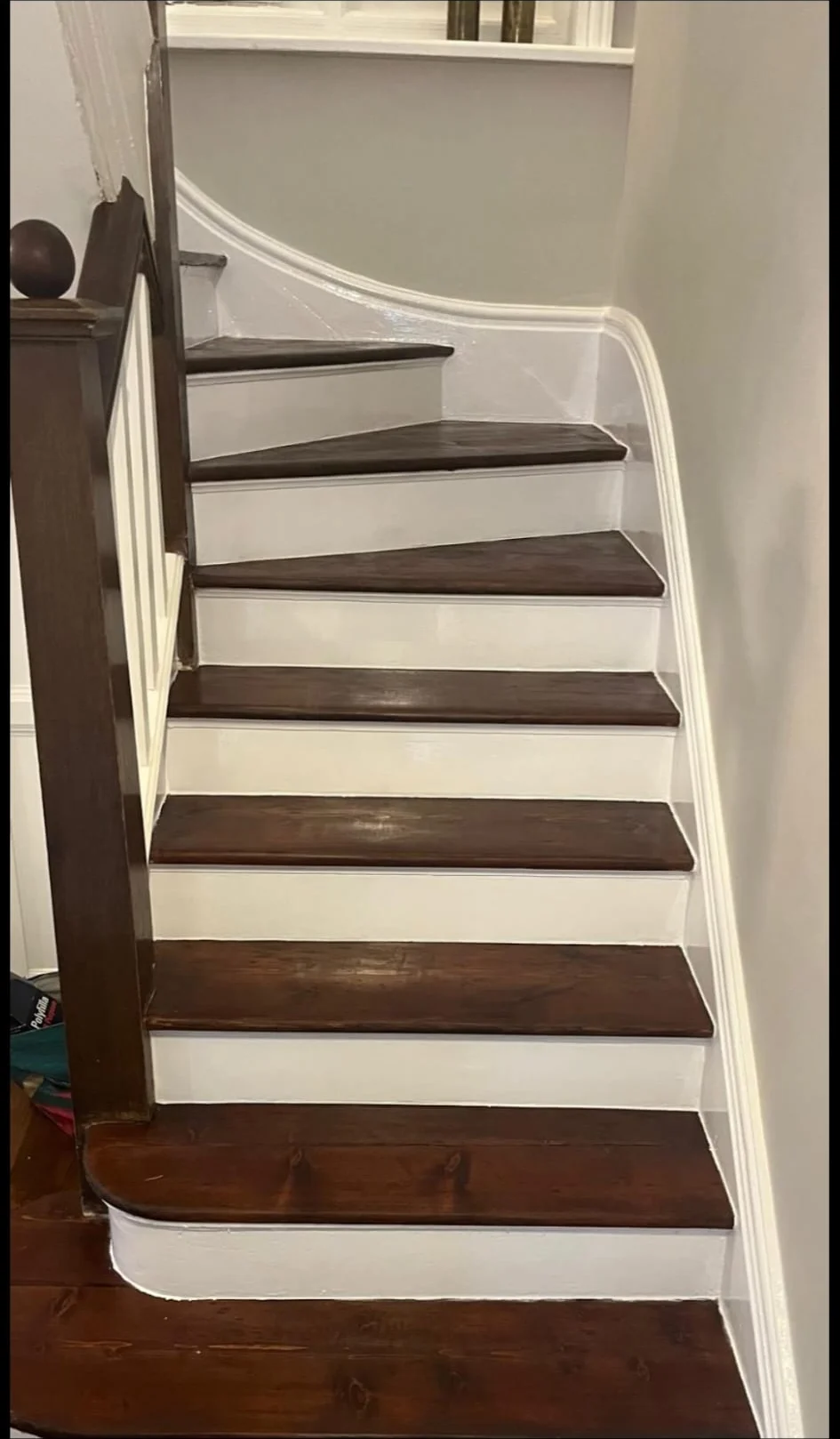 Restored pine staircase in a London home: treads sanded and stained, risers painted white to match the skirting, by Howard Naish