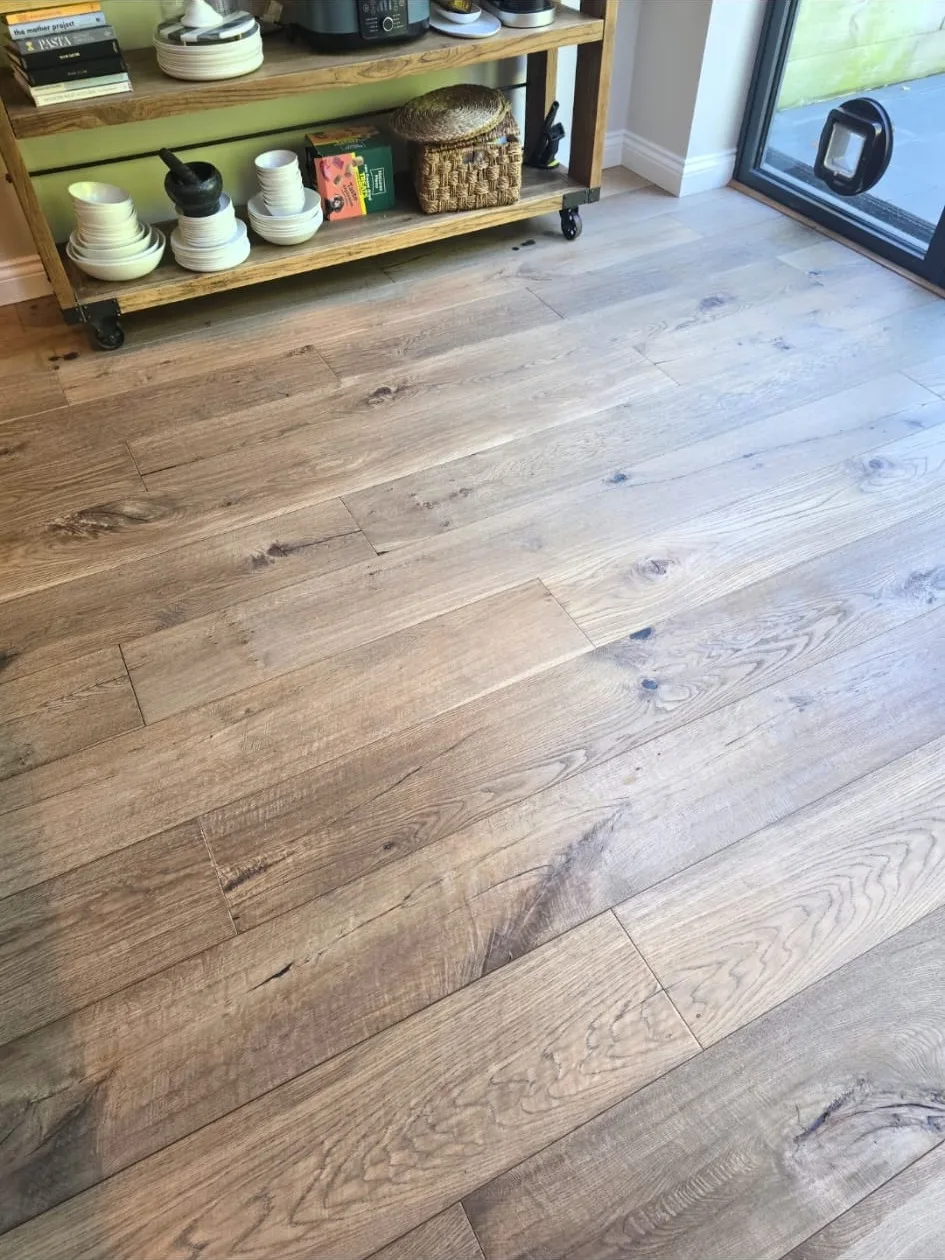 Rustic oak floor in a Tooting kitchen brought back with a light abrasion and fresh lacquer instead of a full sand